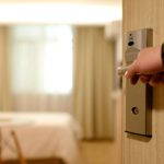 Hotel - Person Holding on Door Lever Inside Room