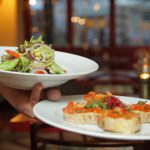 Dining - Person Holding Pastry Dishes on White Ceramic Plates